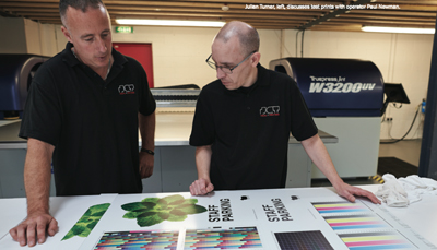 Julian turner, left, discusses test prints with operator Paul Newman